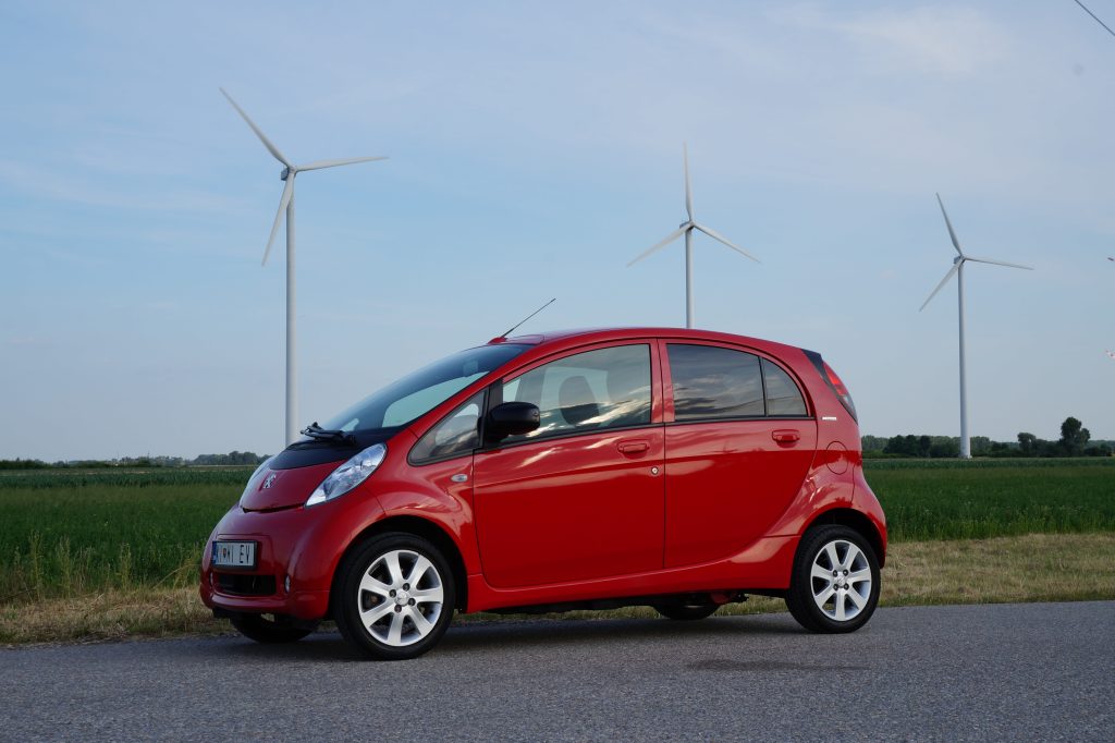 electric car in front of wind turbines royalty free public domain