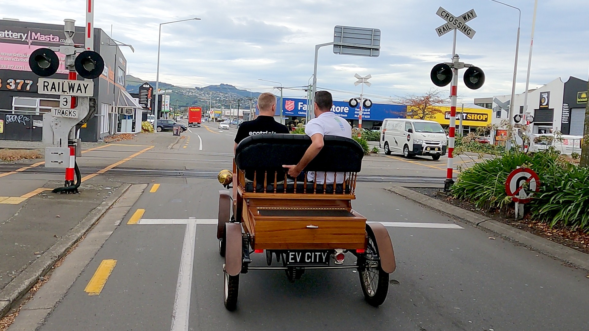 A 1903 Lems electric vehicle crossing railway tracks in the New Zealand city of Christchurch